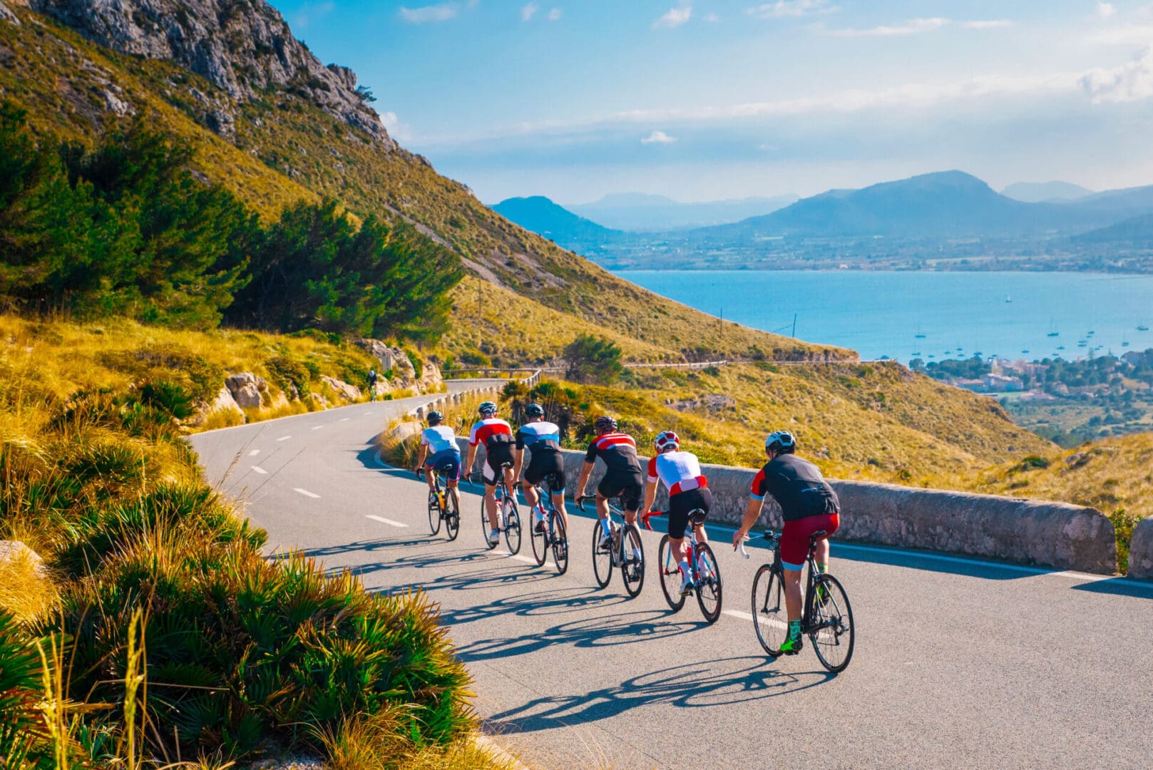 Cyclists riding on scenic coastal road.
