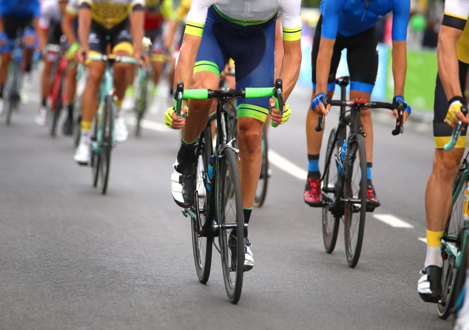 Cyclists racing on a road during competition.