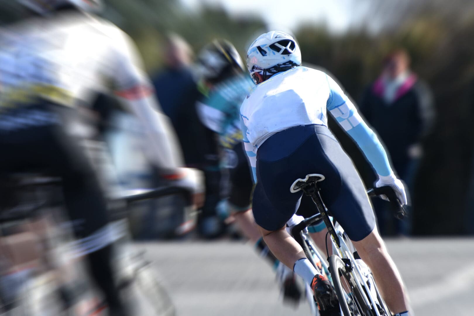 Cyclists racing on a sunny day.